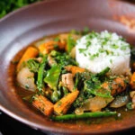 Thai chicken jungle curry (kaeng pa) served with jasmine rice and fresh herbs.