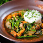 Thai chicken jungle curry (kaeng pa) served with jasmine rice and fresh herbs.