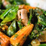 Close-up Thai chicken jungle curry (kaeng pa) served with jasmine rice and fresh herbs.