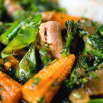 Close-up Thai chicken jungle curry (kaeng pa) served with jasmine rice and fresh herbs.