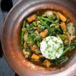 Overhead Thai chicken jungle curry (kaeng pa) served with jasmine rice and fresh herbs.