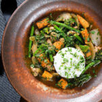 Overhead Thai chicken jungle curry (kaeng pa) served with jasmine rice and fresh herbs.