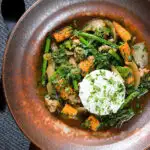 Overhead Thai chicken jungle curry (kaeng pa) served with jasmine rice and fresh herbs.