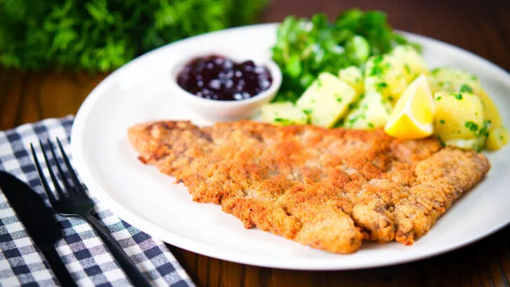 Wiener Schnitzel, breaded veal cutlet with parsley potatoes and red currant jelly.