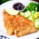 Breaded veal Wiener schnitzel served with parsley buttered potatoes and redcurrant jelly.