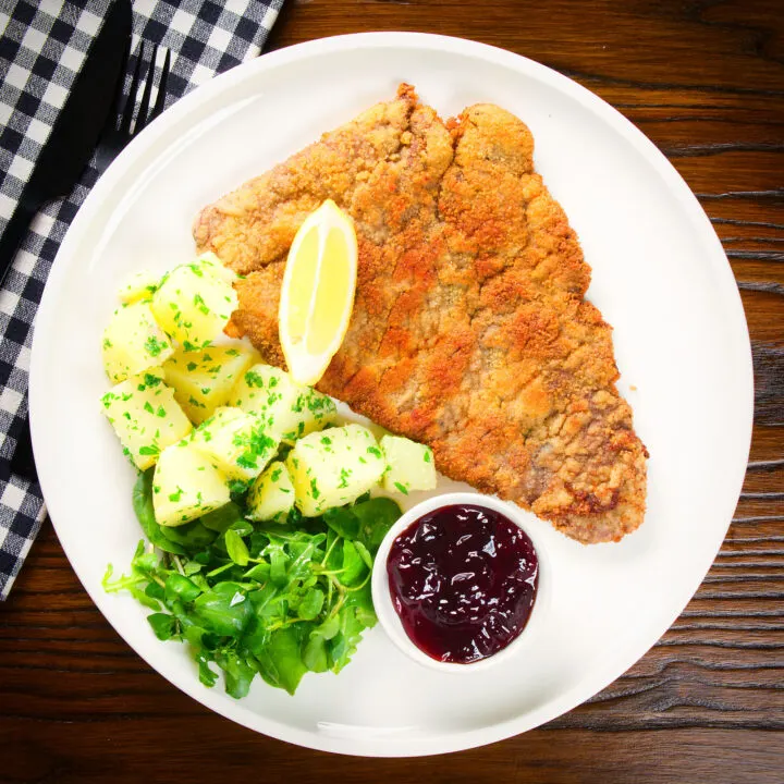 Wiener Schnitzel, breaded veal cutlet with parsley potatoes and red currant jelly.