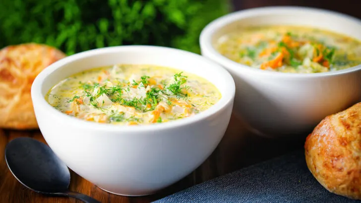 Polish pickle soup or zupa ogorkowa swerved with crusty bread rolls.