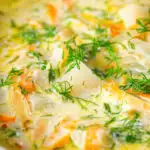 Close-up Polish zupa ogorkowa or pickle (sour) cucumber soup with fresh dill.