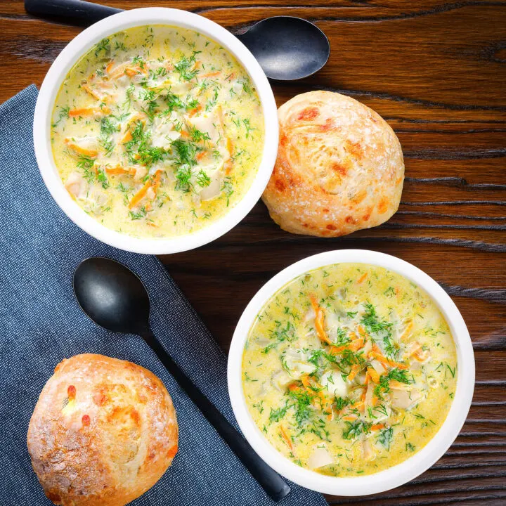 Polish pickle soup or zupa ogorkowa swerved with crusty bread rolls.