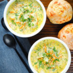 Overhead Polish zupa ogorkowa or pickle (sour) cucumber soup with fresh dill.