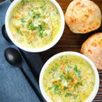 Overhead Polish zupa ogorkowa or pickle (sour) cucumber soup with fresh dill.