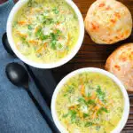 Overhead vegetarian Polish zupa ogorkowa or pickle (sour) cucumber soup with fresh dill.