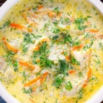 Close-up overhead Polish zupa ogorkowa or pickle (sour) cucumber soup with fresh dill.