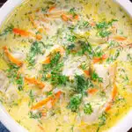Close-up overhead Polish zupa ogorkowa or pickle (sour) cucumber soup with fresh dill.