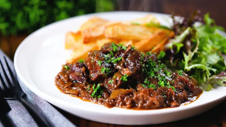 Carbonnade Flamande a Belgian beef and beer stew served with chips and salad.