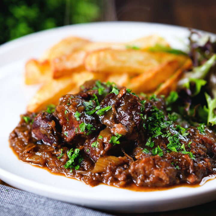 Carbonnade Flamande a Belgian beef and beer stew served with chips and salad.