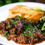 Belgian carbonnade flamande (beef, onion and beer stew) served with chips.