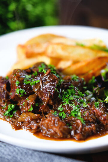Belgian carbonnade flamande (beef, onion and beer stew) served with chips.