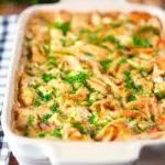 Cauliflower cheese pasta bake served in a baking dish with parsley.