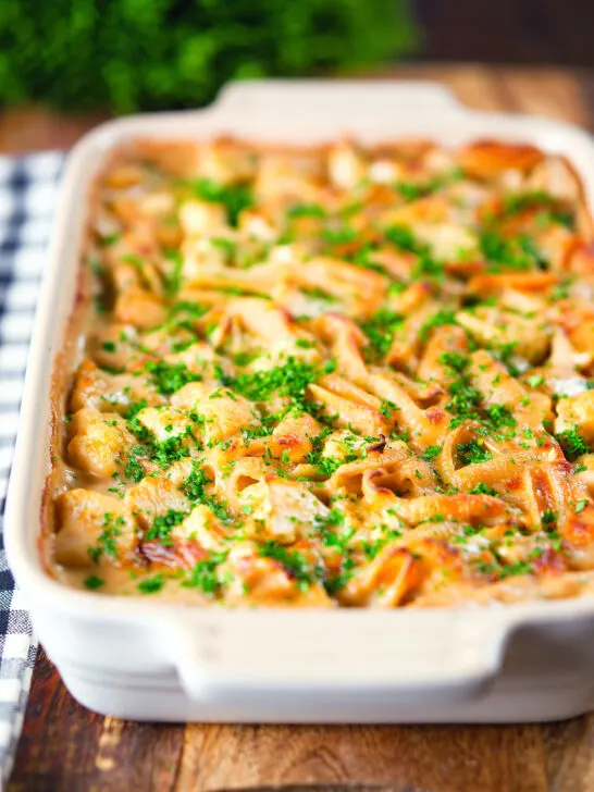 Cauliflower cheese pasta bake served in a baking dish with parsley.