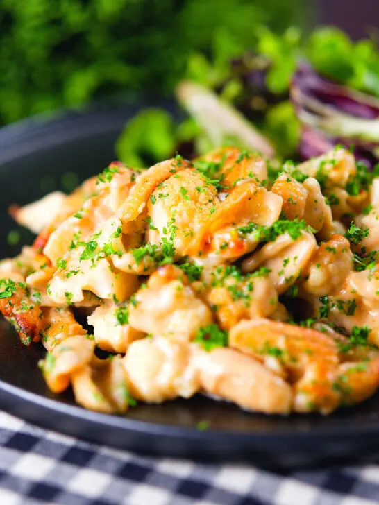 Cauliflower cheese pasta bake served with a side salad.