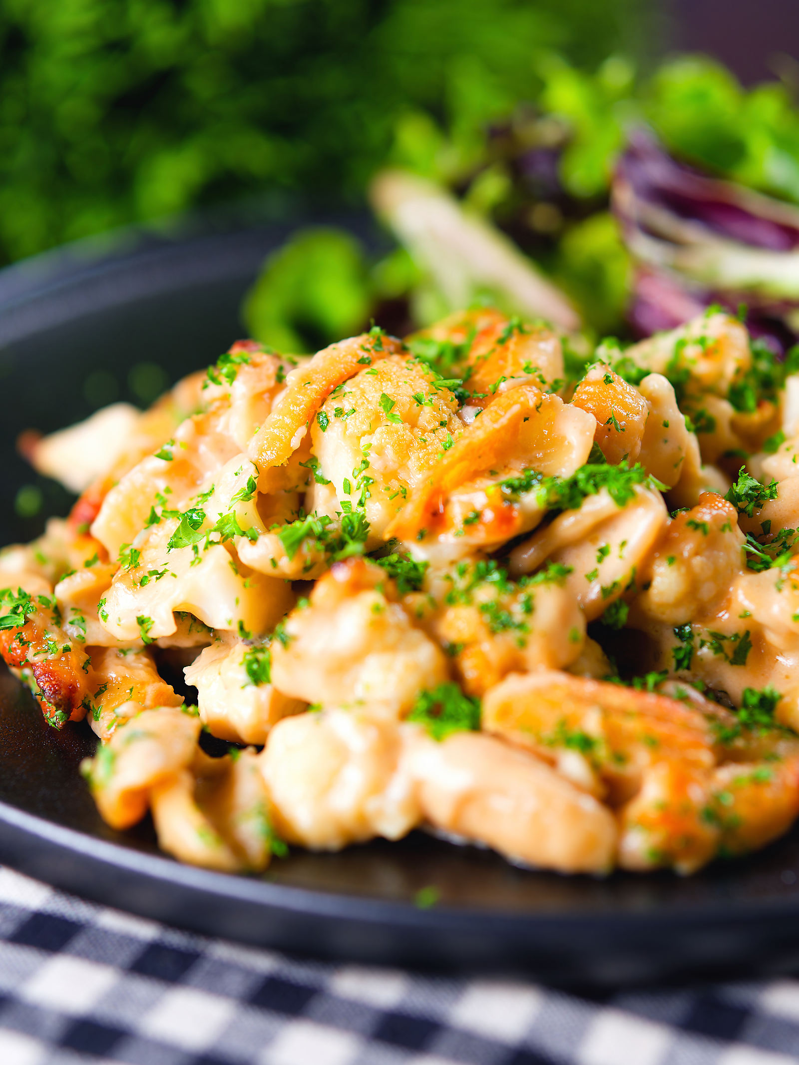 Cauliflower cheese pasta bake served with a side salad.