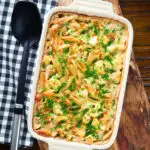Overhead cauliflower cheese pasta bake served in a baking dish with parsley.