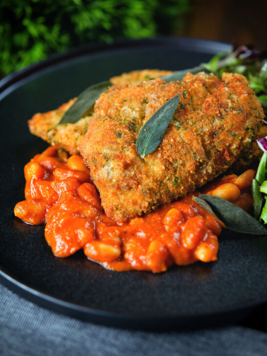 Breaded and fried chicken Milanese served with Italian inspired fagioli all'uccalletto.