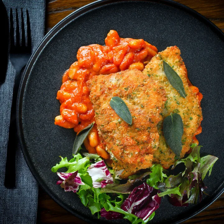 Chicken Milanese (breaded fried chicken culets) served with fagioli all'uccalletto.