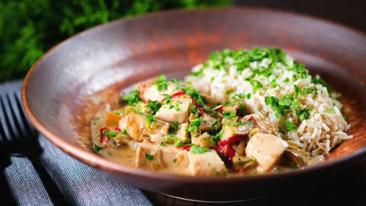 Creamy chicken ala king served with brown rice and fresh parsley.