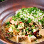 Creamy chicken a la king served with brown rice and parsley.