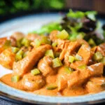 Chicken and mushroom stroganoff served with fried potatoes and chopped gherkins.