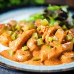 Chicken and mushroom stroganoff served with fried potatoes and chopped gherkins.