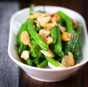 Buttery garlic green beans amandine aka almondine.