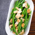 Overhead garlic green beans amandine aka almondine.