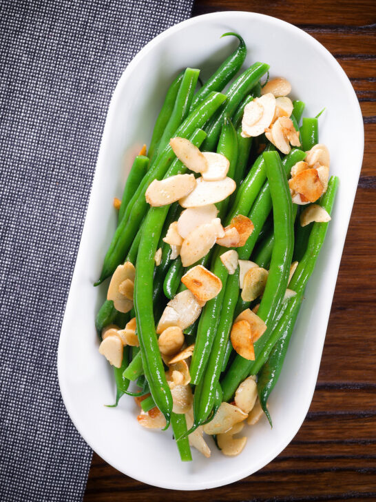 Overhead garlic green beans amandine aka almondine.