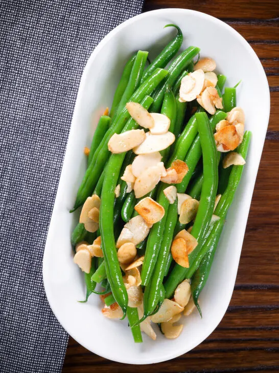 Overhead garlic green beans amandine aka almondine.