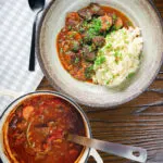 Overhead Greek beef and tomato stew (kokkinisto) served with celeriac mash in a bowl.