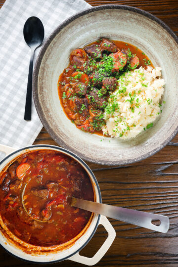 Overhead Greek beef and tomato stew (kokkinisto) served with celeriac mash in a bowl.