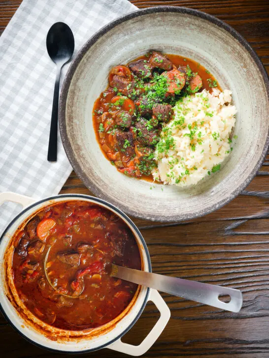 Overhead Greek beef and tomato stew (kokkonisto) served with celeriac mash in a bowl.