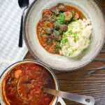 Overhead Greek beef and tomato stew (kokkinisto) served with celeriac mash in a bowl.