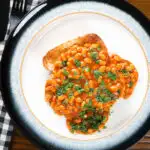 Overhead Indian-inspired spicy masala baked beans on toast with fresh coriander.