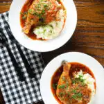 Overhead poulet au vinaigre, chicken legs in garlic and vinegar served with celeriac mash.