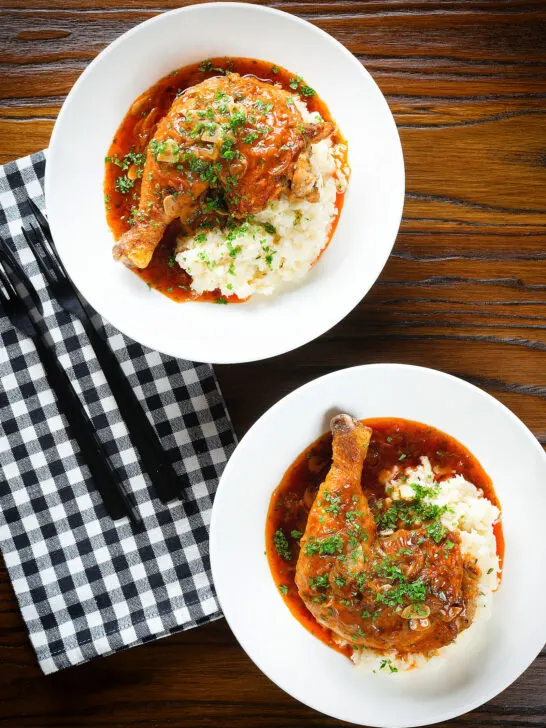 Overhead poulet au vinaigre, chicken legs in garlic and vinegar served with celeriac mash.