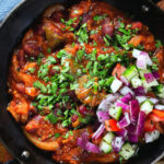 Overhead close-up rajma masala (kidney bean curry) served with kachumber salad.