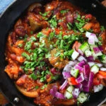Overhead close-up rajma masala (kidney bean curry) served with kachumber salad.