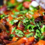 Close-up rajma masala (kidney bean curry) served with kachumber salad.