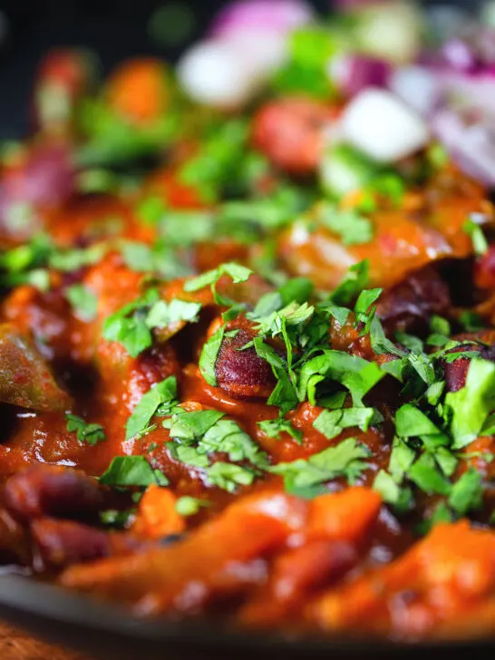 Close-up rajma masala (kidney bean curry) served with kachumber salad.