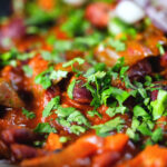 Close-up rajma masala (kidney bean curry) served with kachumber salad.