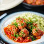 Spicy Moroccan-influenced lamb (kefta) meatball tagine served with herby buttered couscous.